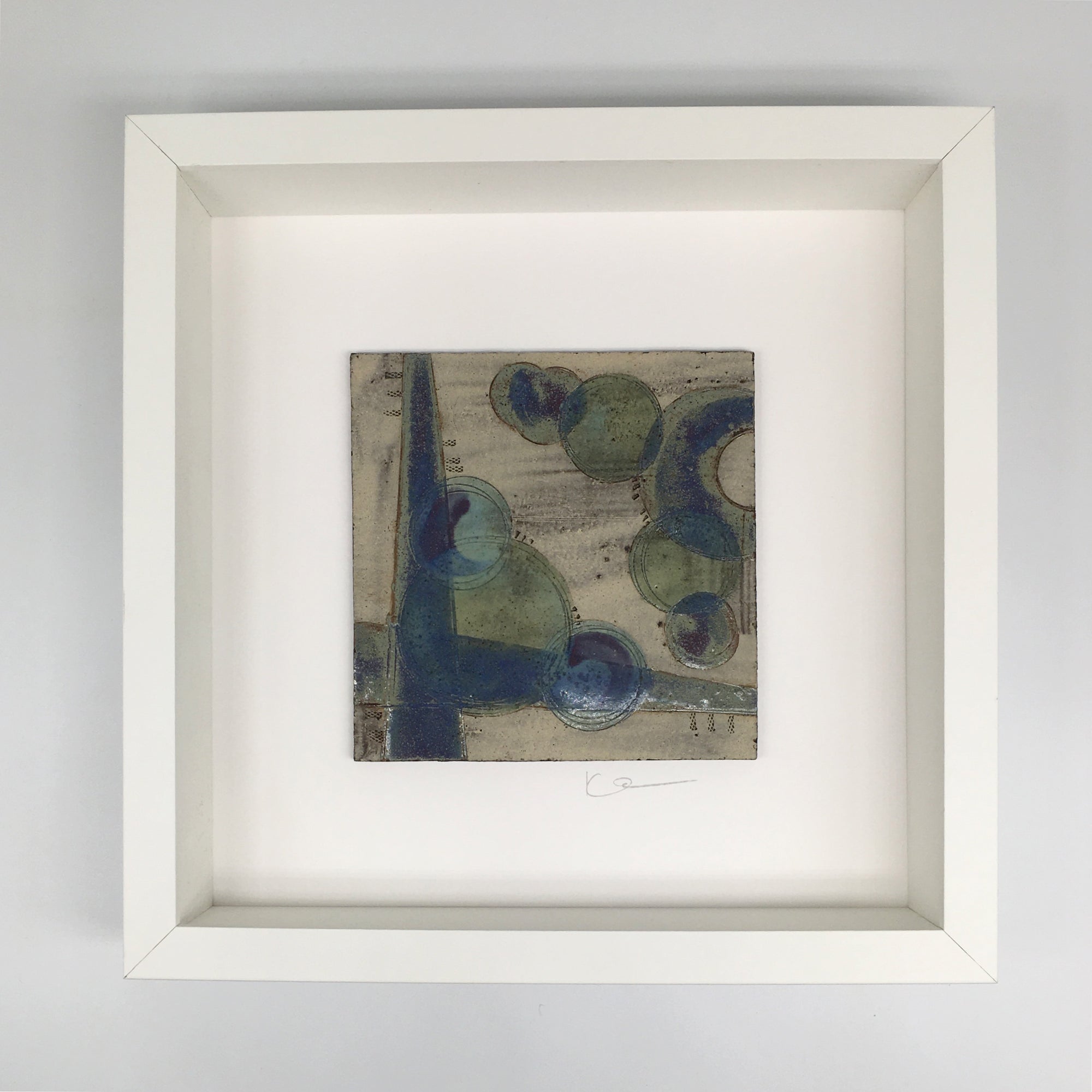 A framed small wall plaque - purple green crescent and bold lines with green turquoise spots