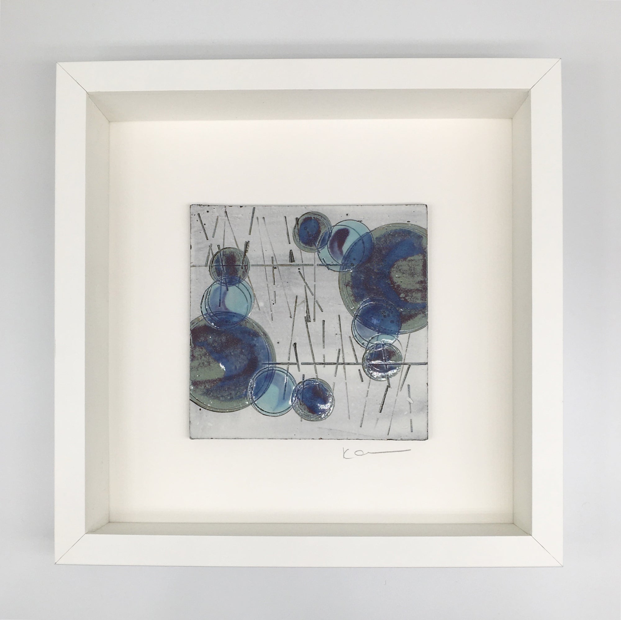 A framed small wall plaque -purple circles, turquoise spots and lines