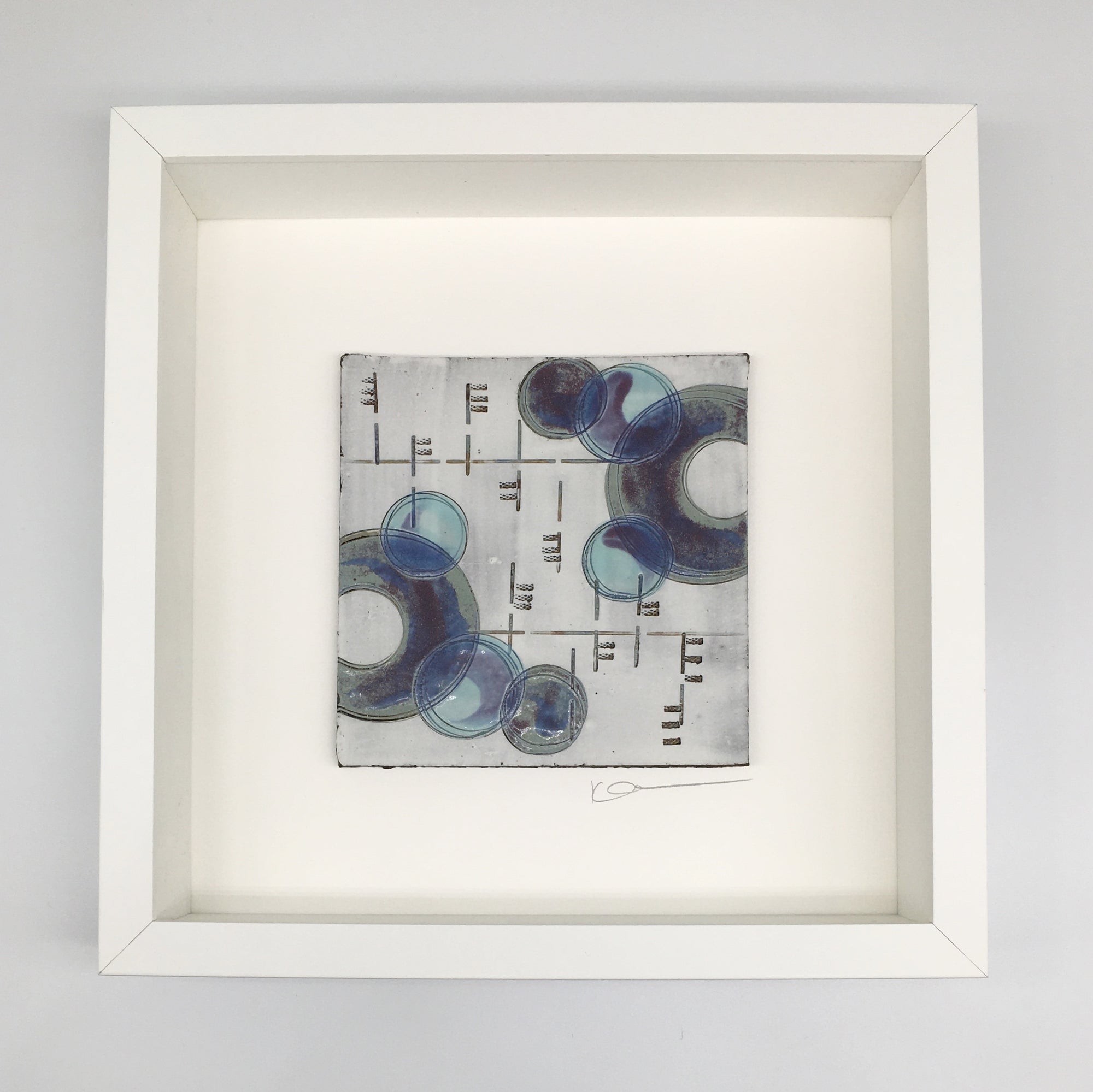 A framed small wall plaque - purple line and crescents