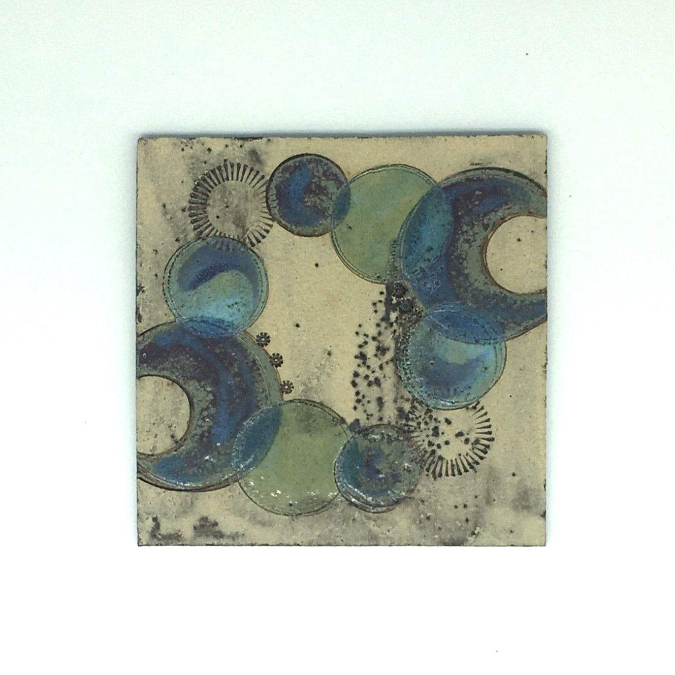 Small wall plaque - muted colours with purple green crescents and circles
